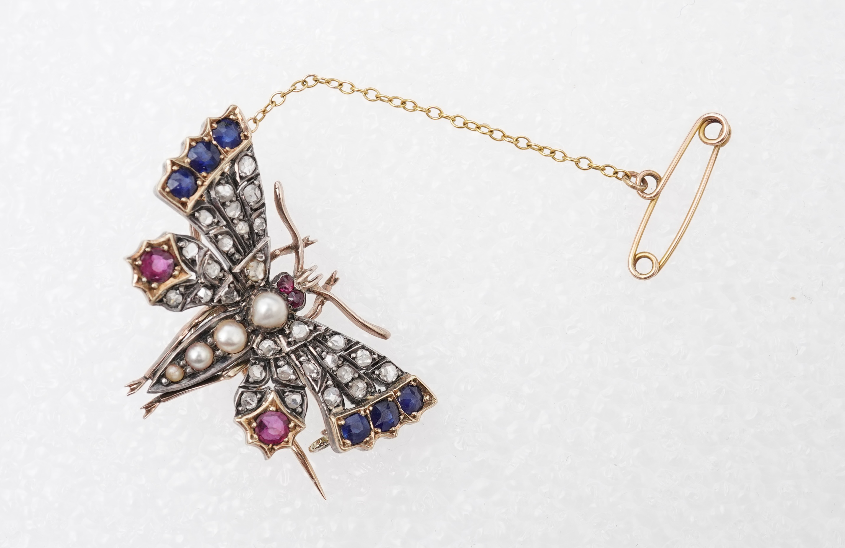 A Victorian ruby, sapphire, pearl and diamond brooch, late 19th century